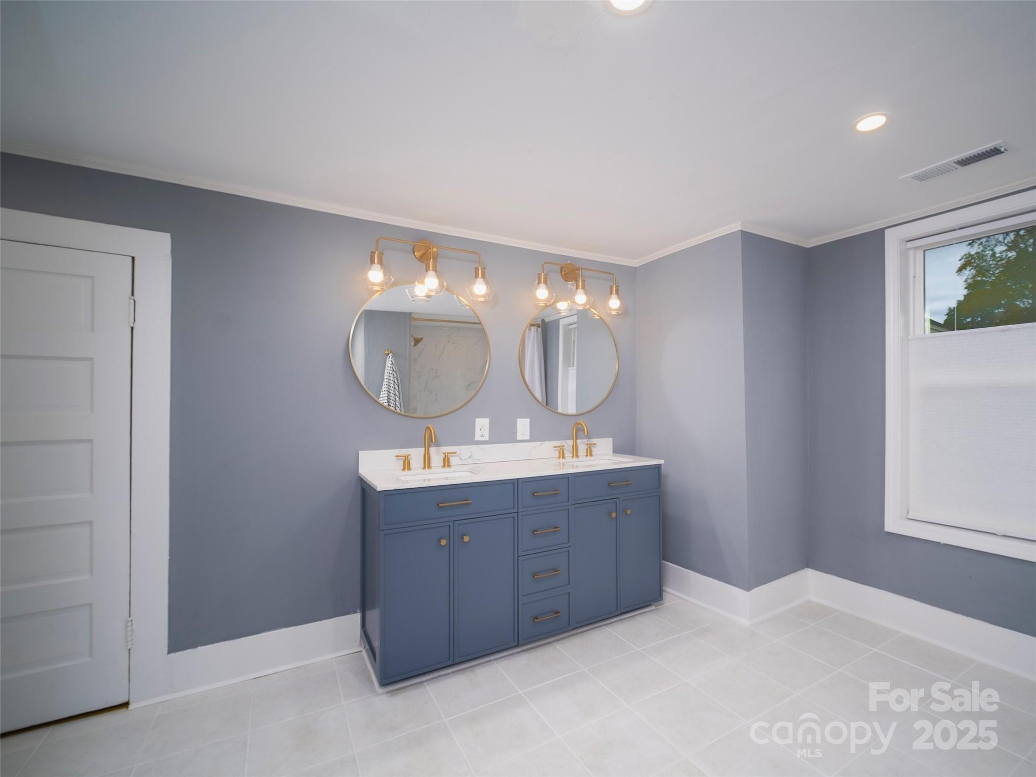 525 West 2nd Avenue Gastonia, NC 28052 - Photo 24 of 39 a room with a mirror a double vanity sink and a mirror