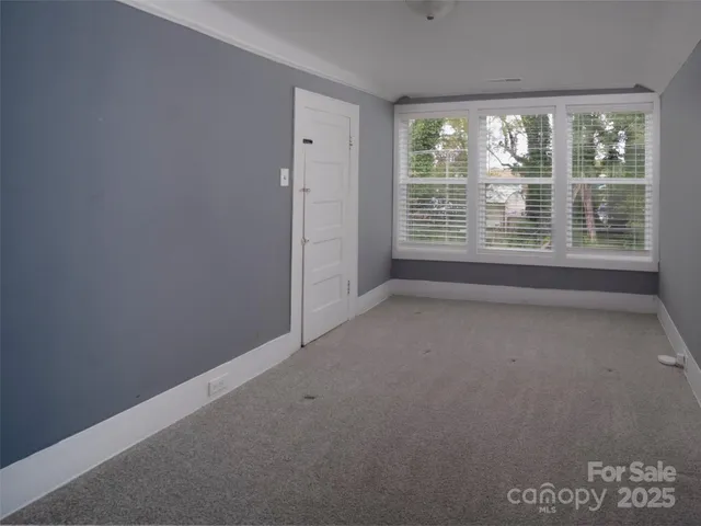 a view of an empty room with a closet