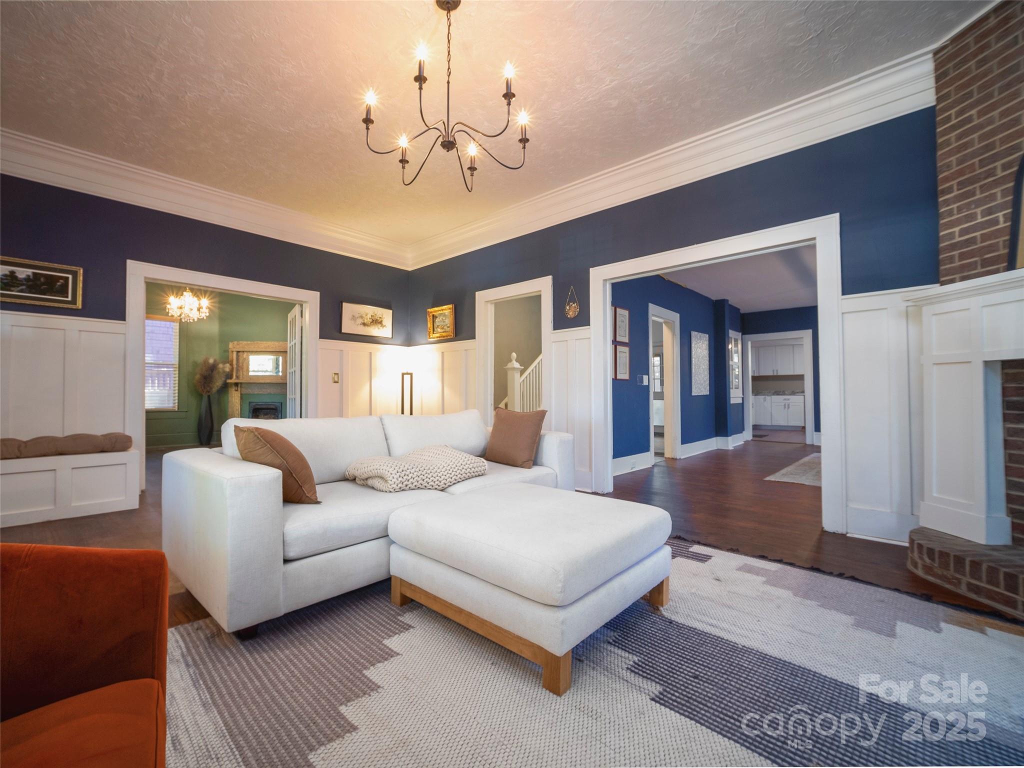 525 West 2nd Avenue Gastonia, NC 28052 - Photo 3 of 39 a living room with furniture and a chandelier