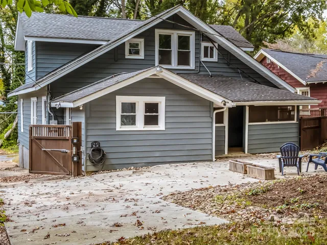 a front view of a house with a yard covered in snow