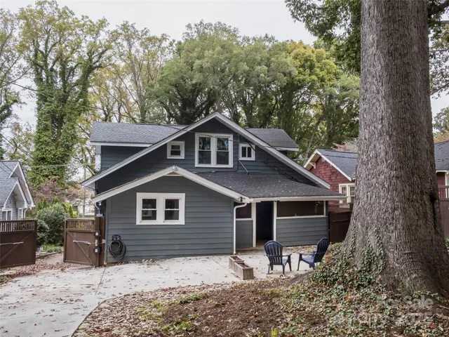 a view of backyard with seating space and trees