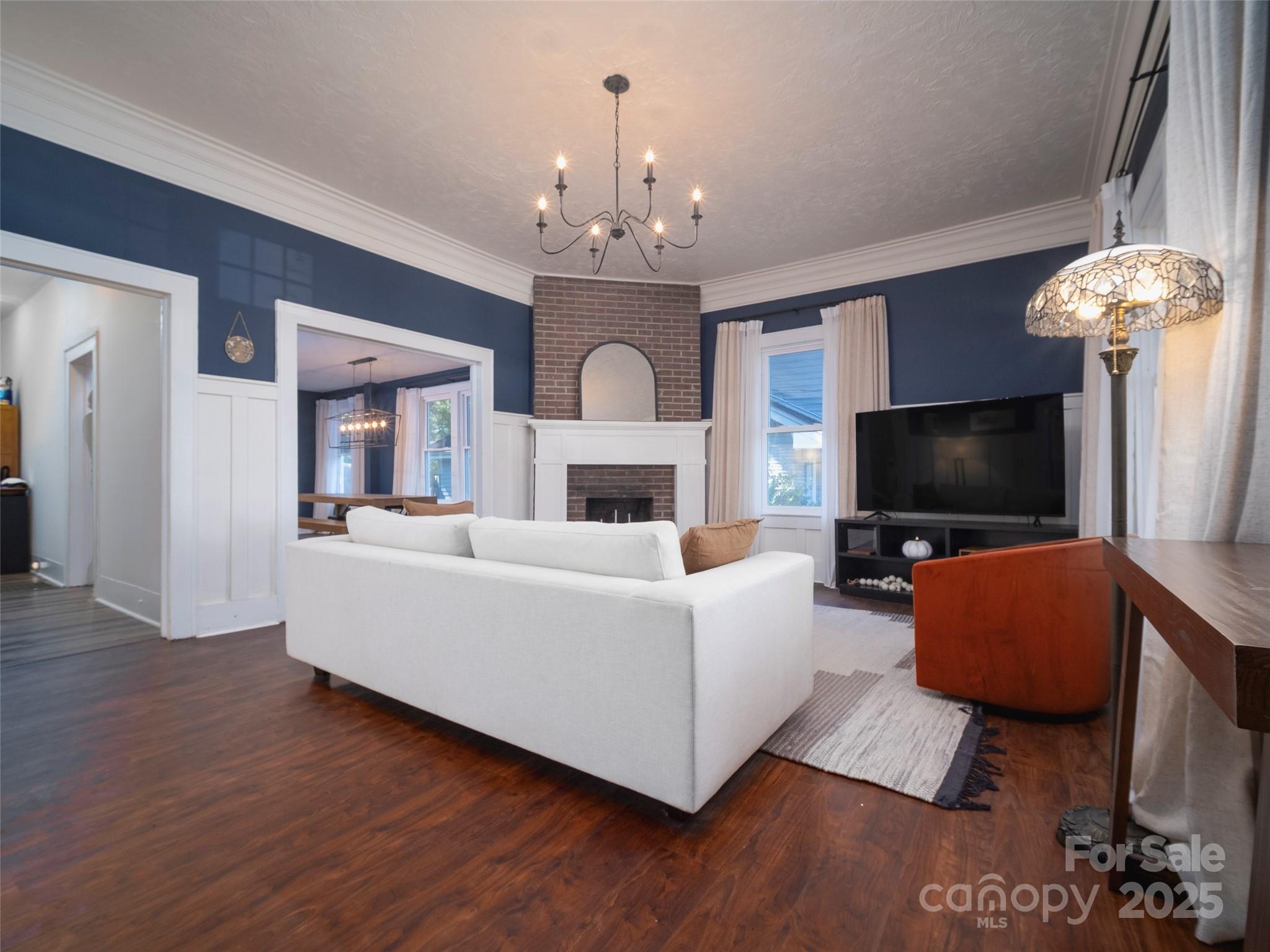 525 West 2nd Avenue Gastonia, NC 28052 - Photo 4 of 39 a living room with furniture and a flat screen tv