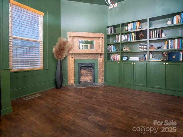 a view of a livingroom with furniture and a bookshelf