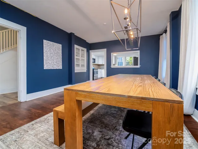 a bed sitting in a spacious bedroom next to a window