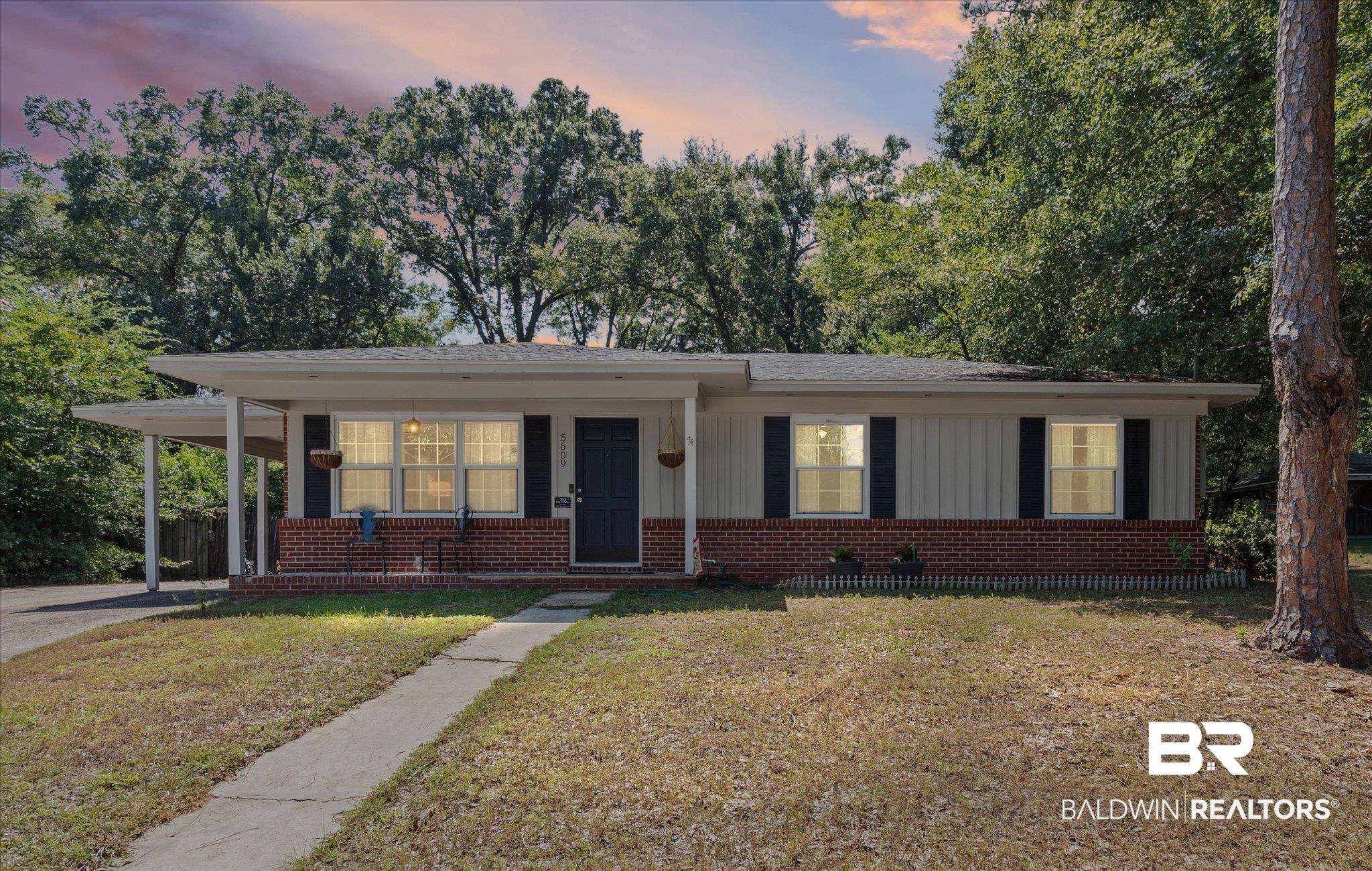 5609 Diane Court Mobile, AL 36618 - Photo 1 of 22 Ranch-style home with a yard, covered porch, board and batten siding, and brick siding