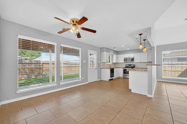a view of a kitchen with furniture and windows