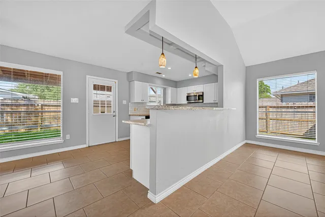 a kitchen with a sink a counter top space stainless steel appliances and cabinets