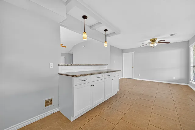 a view of a kitchen with a sink and chandelier fan