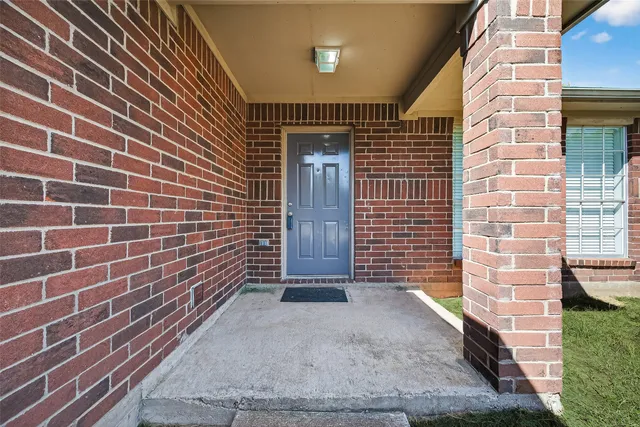 an empty room with windows and chandelier