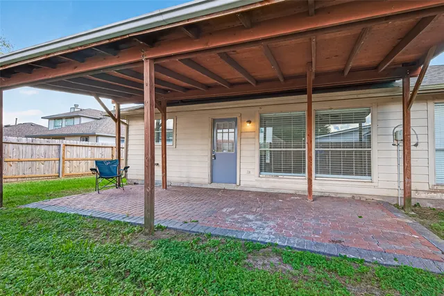 a view of a wooden house with a backyard