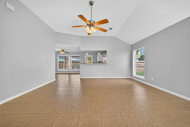 a view of room with a ceiling fan and window