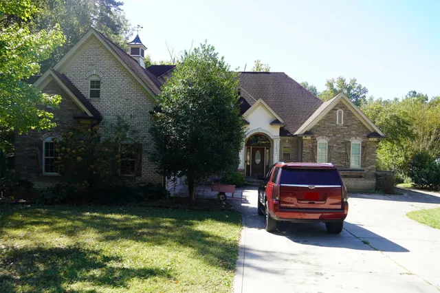 a car parked in front of a house with yard