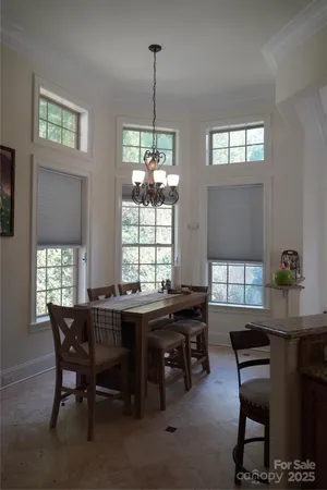 a view of a dining room with furniture and window