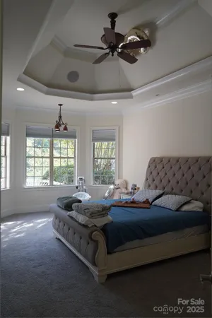 a bedroom with bed couch and window