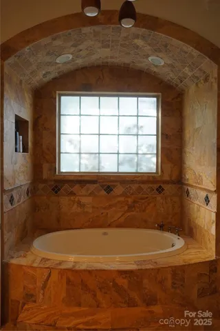 a bathroom with a bathtub and shower