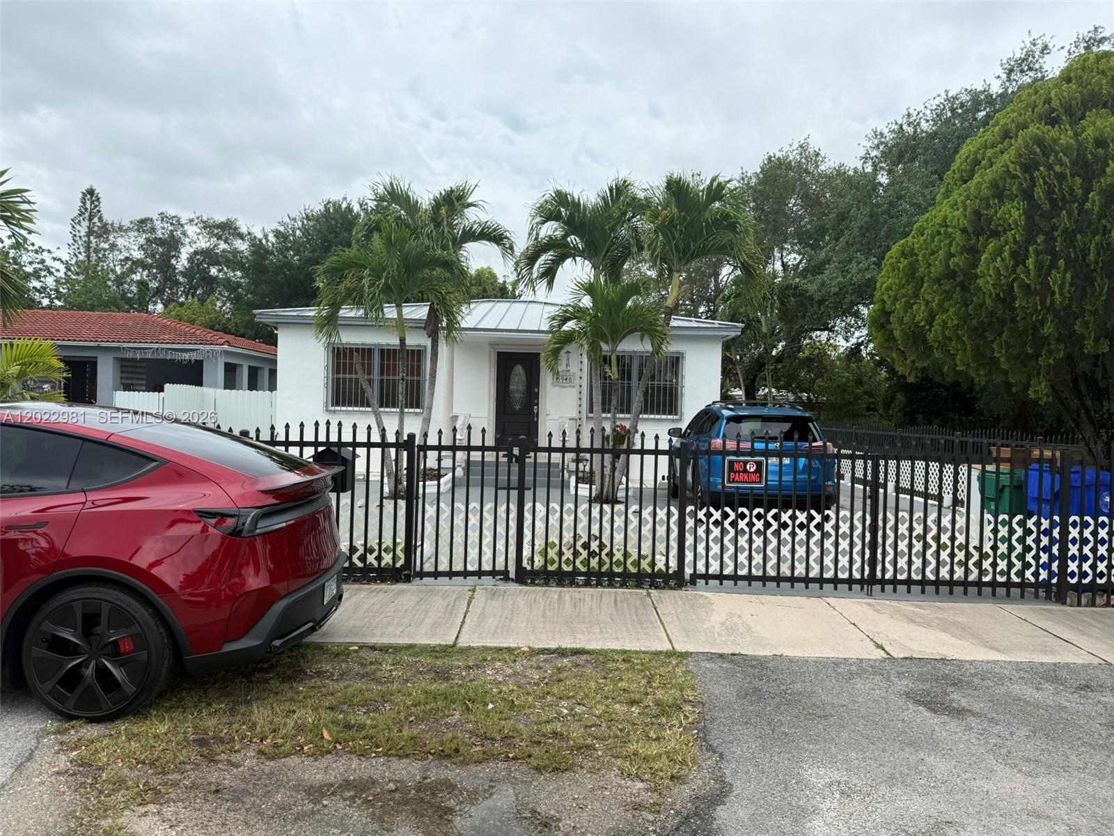 5940 Southwest 2nd Street Miami, FL 33144 - Photo 5 of 22 a front view of a house with a garden