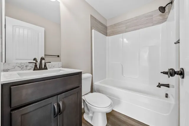 a view of a livingroom with a ceiling fan and window