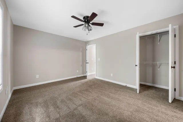 a bathroom with a sink a toilet a mirror and shower