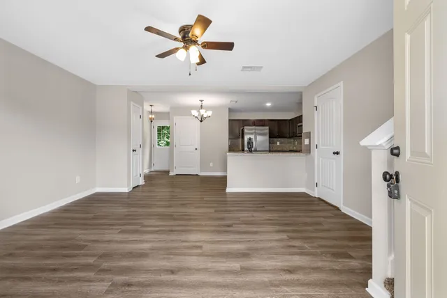a view of a kitchen with a sink and a refrigerator