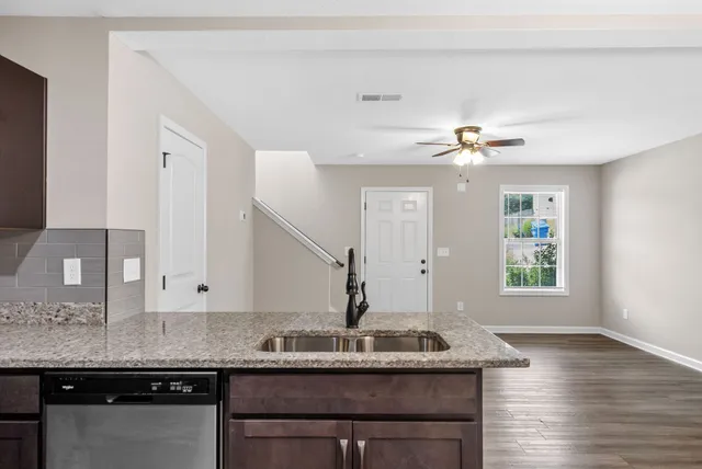 a kitchen with stainless steel appliances granite countertop a sink and a granite counter tops