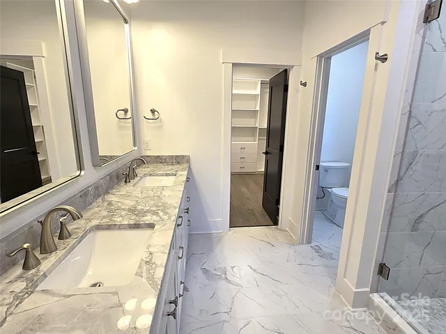 a bathroom with a granite countertop tub sink and mirror