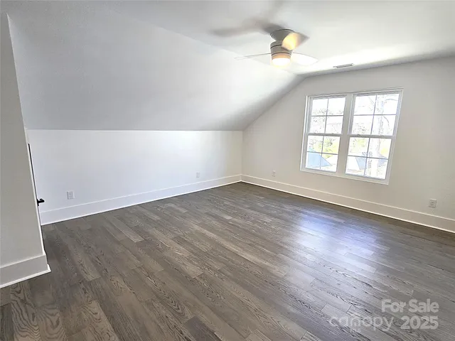 an empty room with wooden floor and closet