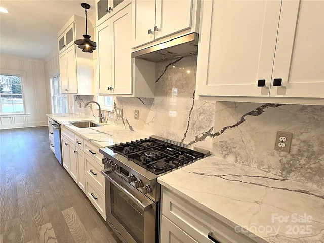 a kitchen with sink stove and cabinets