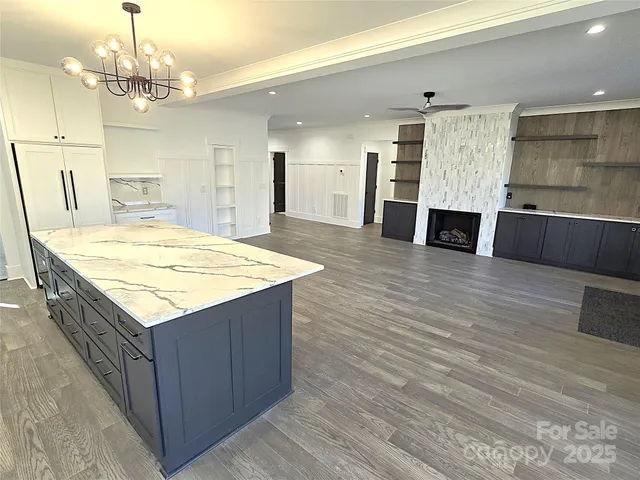 a kitchen with kitchen island wooden cabinets and center island