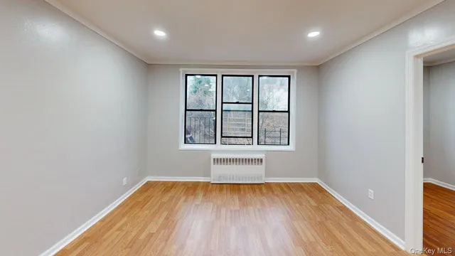 wooden floor in an empty room with a window