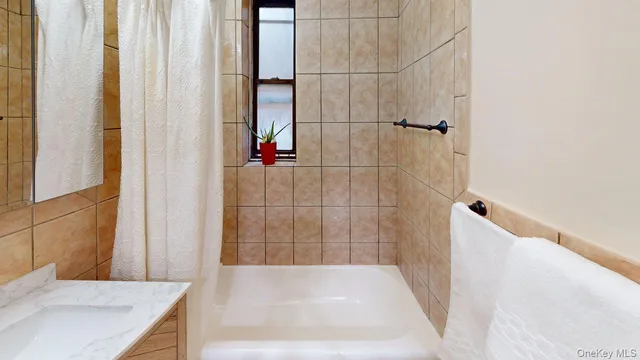a bathroom with a granite countertop shower and a sink