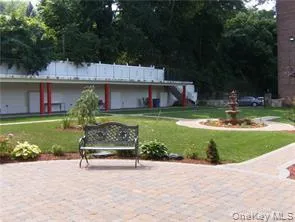 a view of backyard with outdoor seating and green space