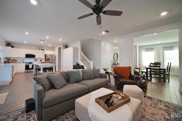a living room with furniture kitchen view and a table