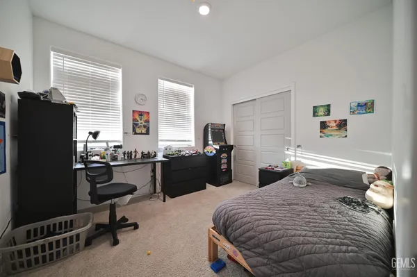 a bedroom with a bed a desk and chair