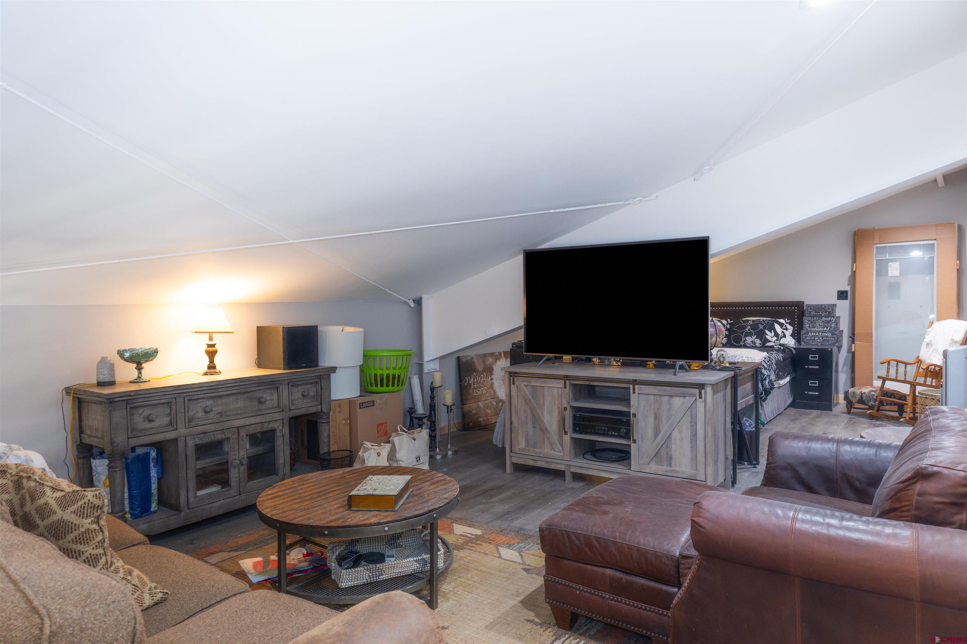 2632 Taylor Ranch Road Durango, CO 81301 - Photo 13 of 35 a living room with furniture and a flat screen tv