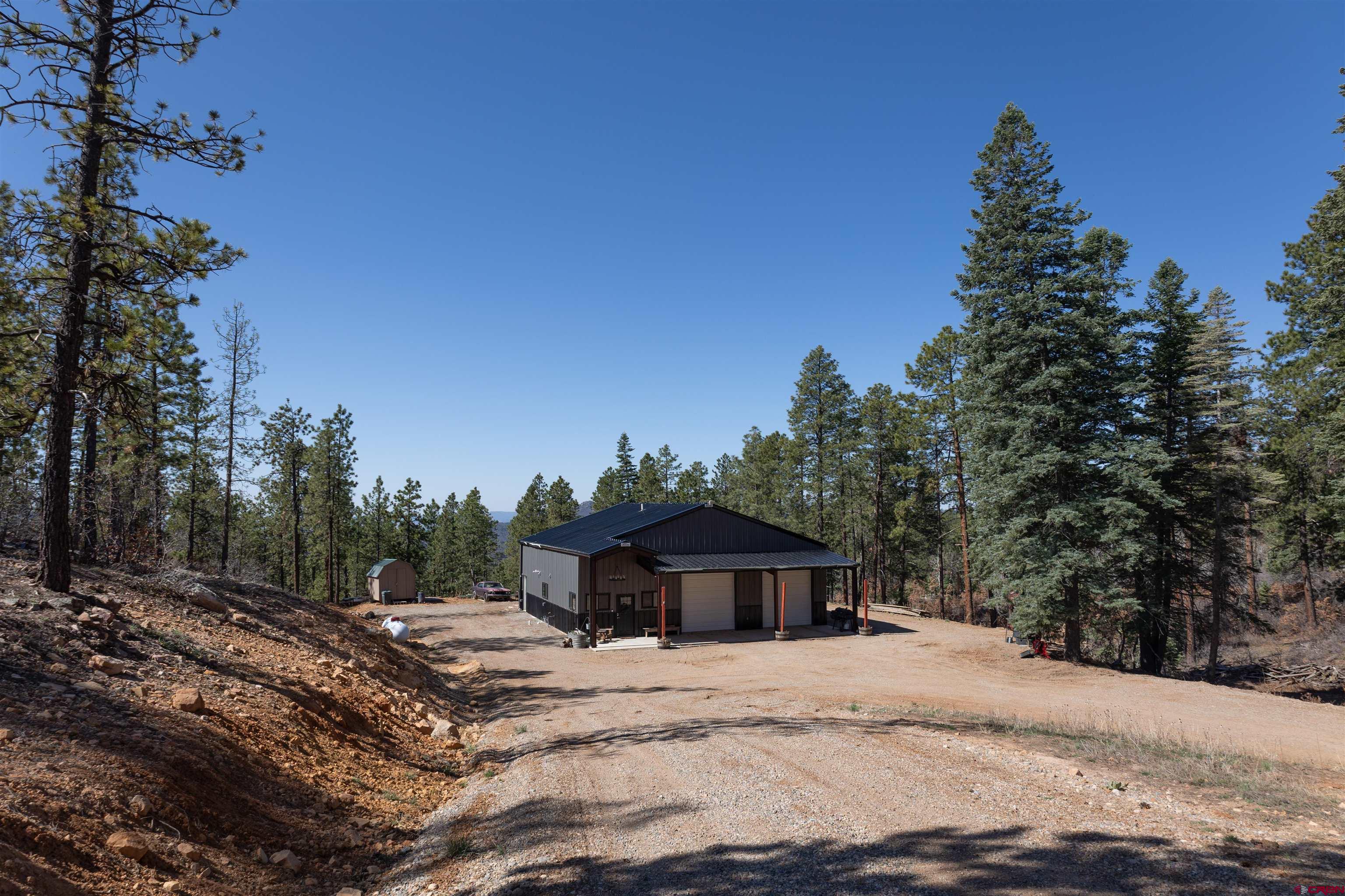 2632 Taylor Ranch Road Durango, CO 81301 - Photo 22 of 35 a view of a wooden house with a yard