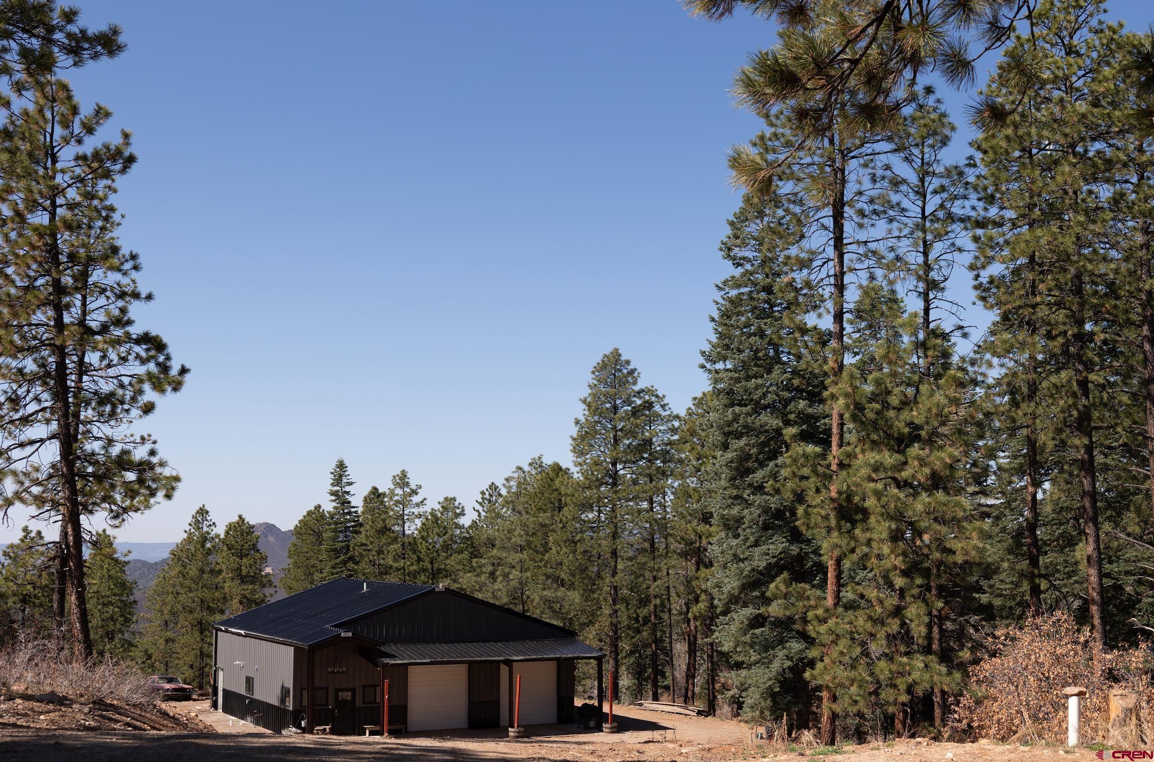 2632 Taylor Ranch Road Durango, CO 81301 - Photo 24 of 35 a front view of a house with a yard and trees