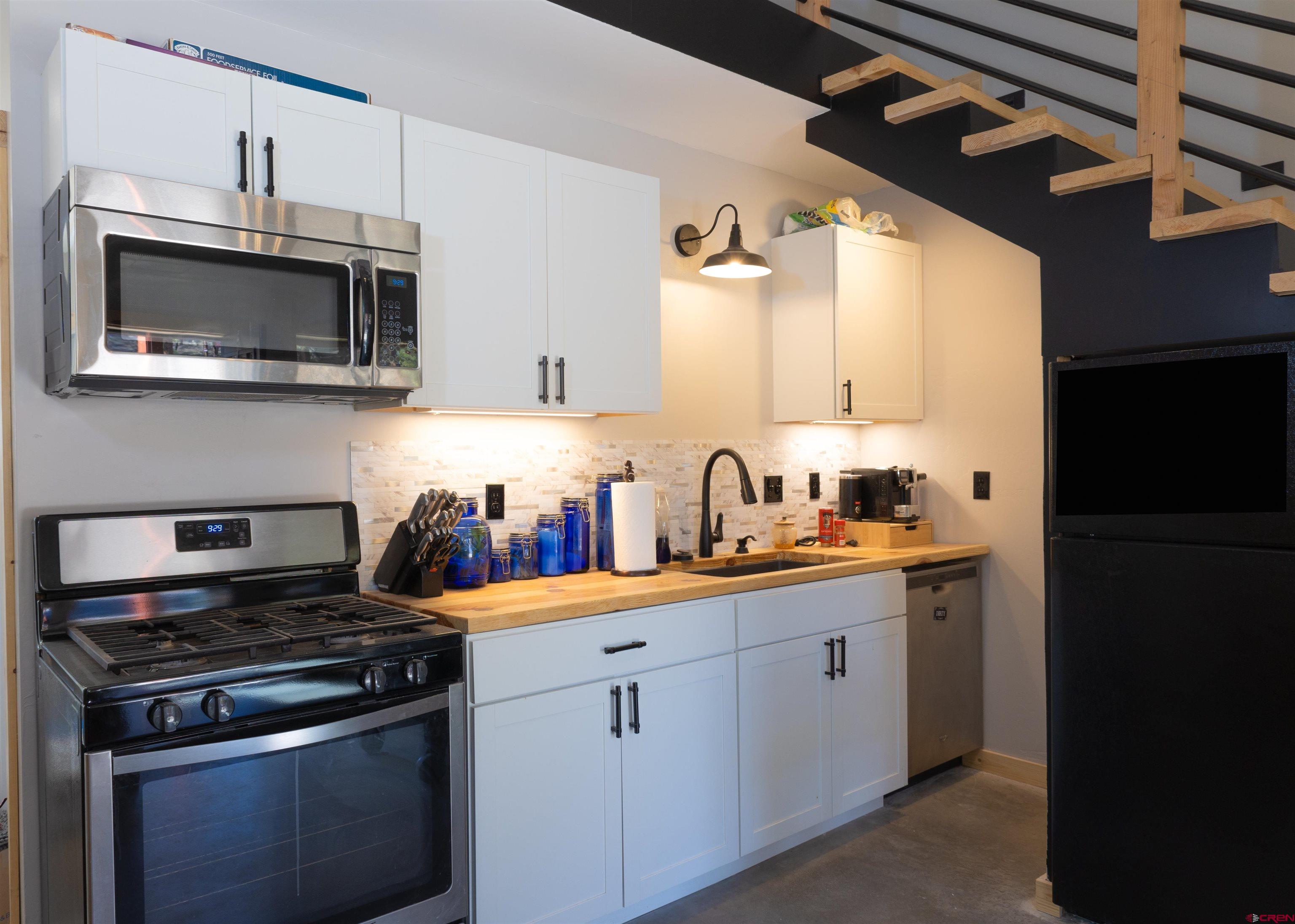 2632 Taylor Ranch Road Durango, CO 81301 - Photo 8 of 35 a kitchen with stainless steel appliances a sink stove and microwave