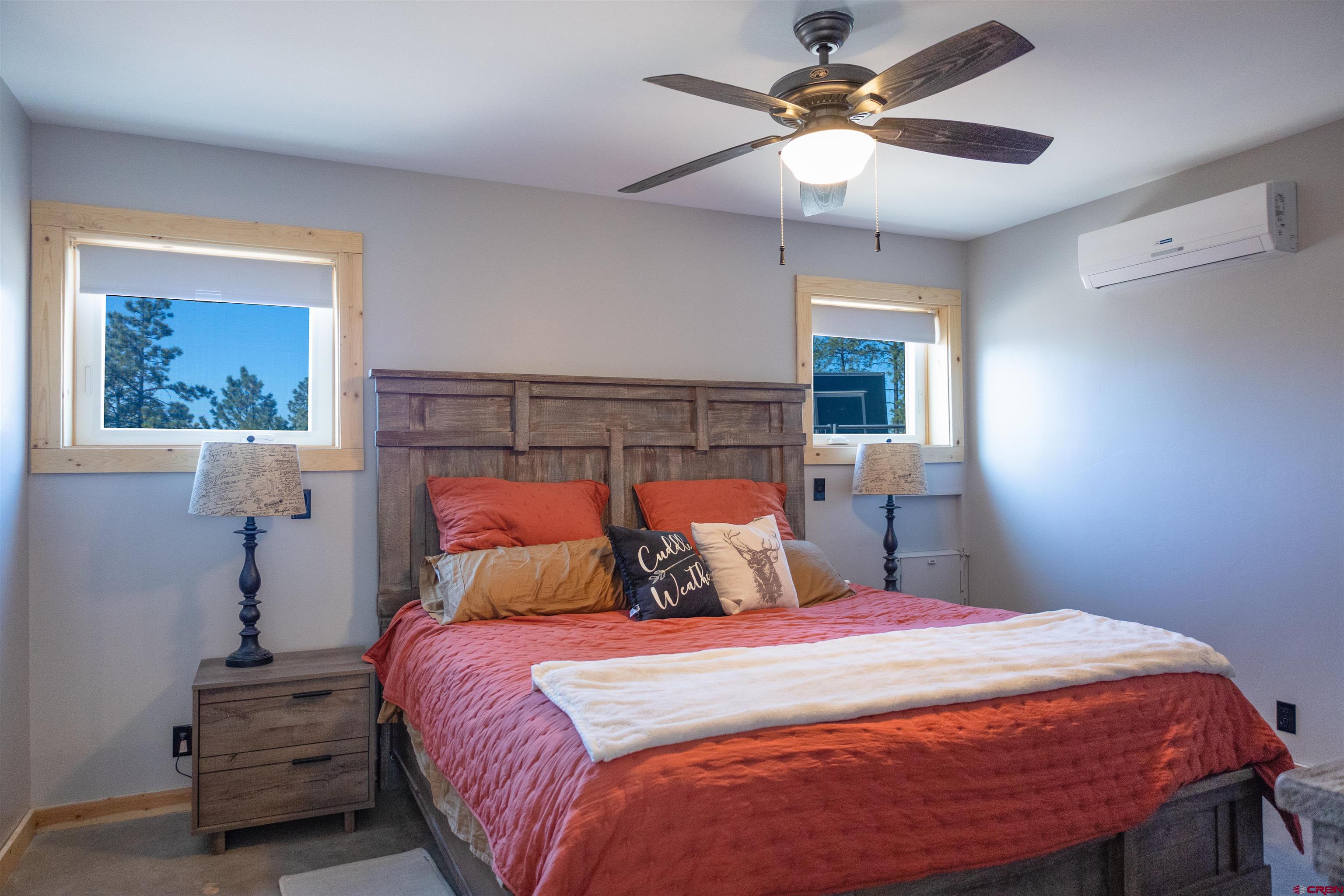 2632 Taylor Ranch Road Durango, CO 81301 - Photo 10 of 35 a bedroom with a bed and a chandelier