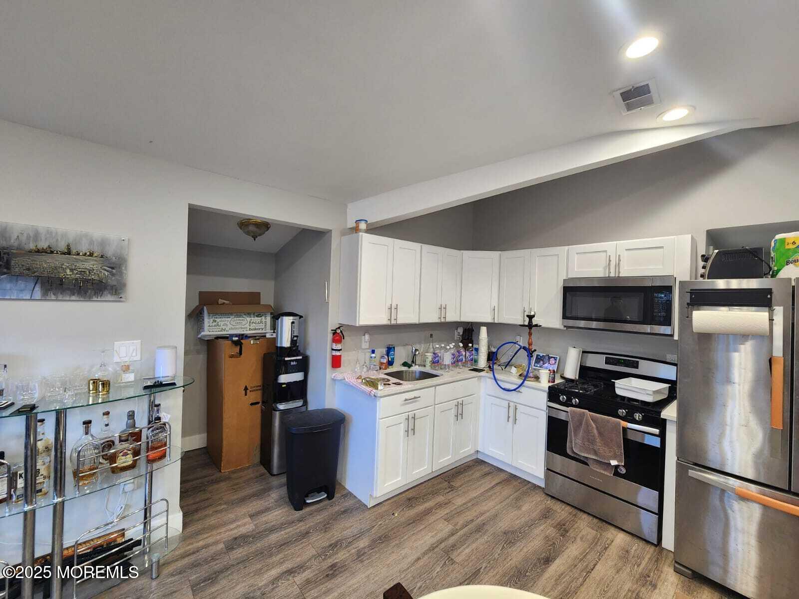 215 Miller Road Lakewood, NJ 08701 - Photo 3 of 12 a kitchen with stainless steel appliances and a refrigerator