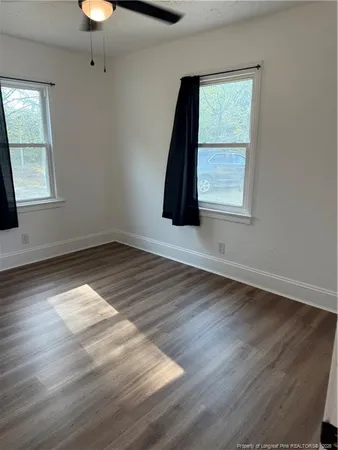 wooden floor in an empty room with a window