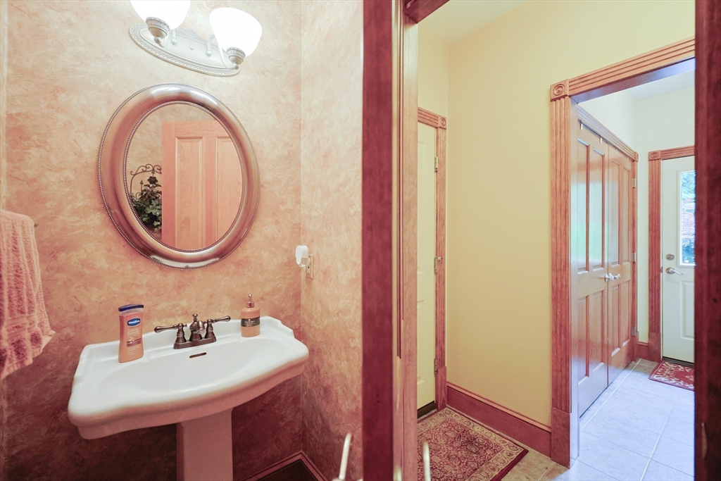 70 Azalea Way Hanson, MA 02341 - Photo 20 of 42 a bathroom with a sink and a mirror