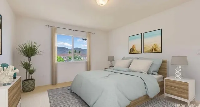 a bedroom with a large bed and a potted plant