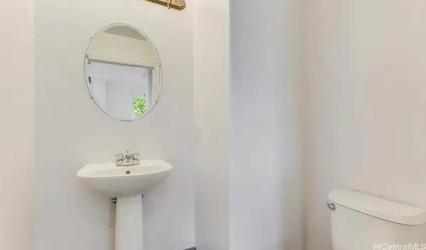 a bathroom with a sink a mirror and toilet