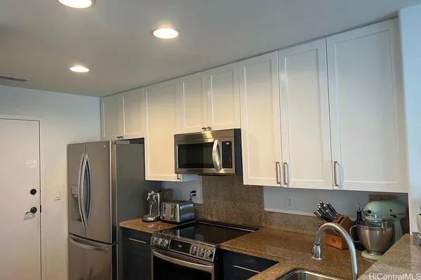 a kitchen with a refrigerator stove and microwave