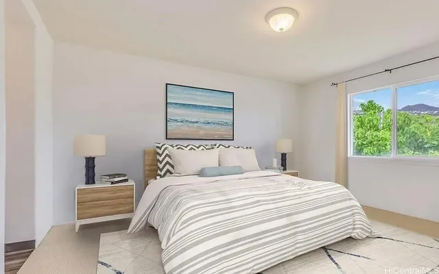 a bedroom with a bed and a painting on the wall