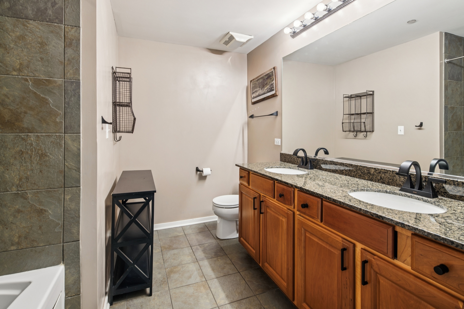 520 South State Street, Unit 816 Chicago, IL 60605 - Photo 11 of 15 a spacious bathroom with a granite countertop sink a toilet and a mirror
