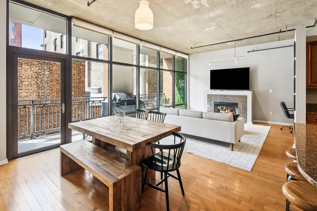 a living room with furniture a flat screen tv and a large window