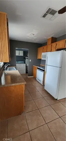 a kitchen with a sink and a refrigerator