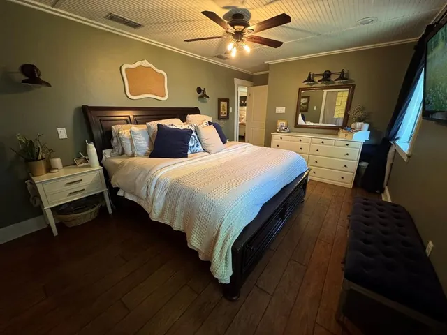 a bed sitting in a bedroom next to a window