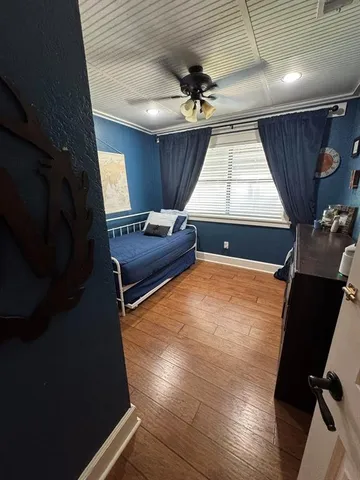 a bedroom with bed and a wall painting